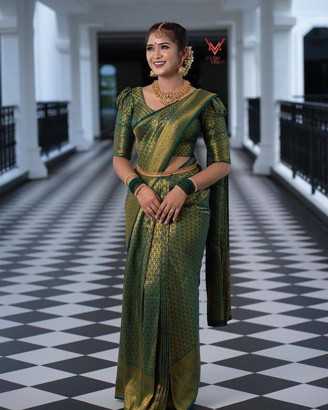 Zari Weaving Work Adorned Soft Lichi Silk Saree in Dark Green